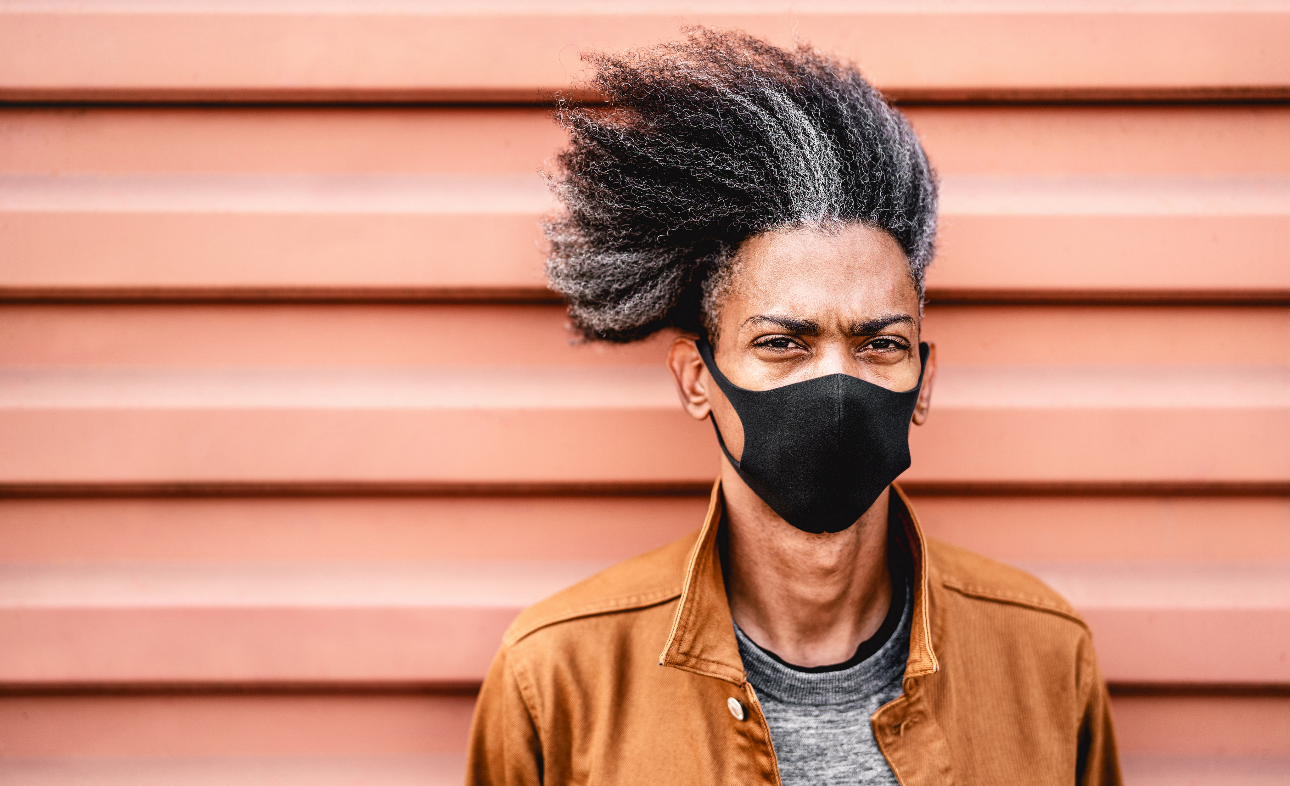 Portrait of african american guy wearing black protective face mask